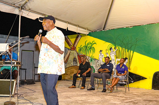 Former Member of Parliament Derrick Kellier here speaking at the 2019 Sam Sharpe Commemoration ceremony at Tulloch Castle,was the guiding light behind the thrust in St. James to recognize the the work and worth of Sam Sharpe, and enlisted the assistance of Jamaica's foremost culture specialist Sydney Bartley (sitting at far left) in promoting the idea to the country at large. Also in the picture are SDC Parish Manager Mr. Randy Hale and SDC Officer Ms Lesline Harvey.