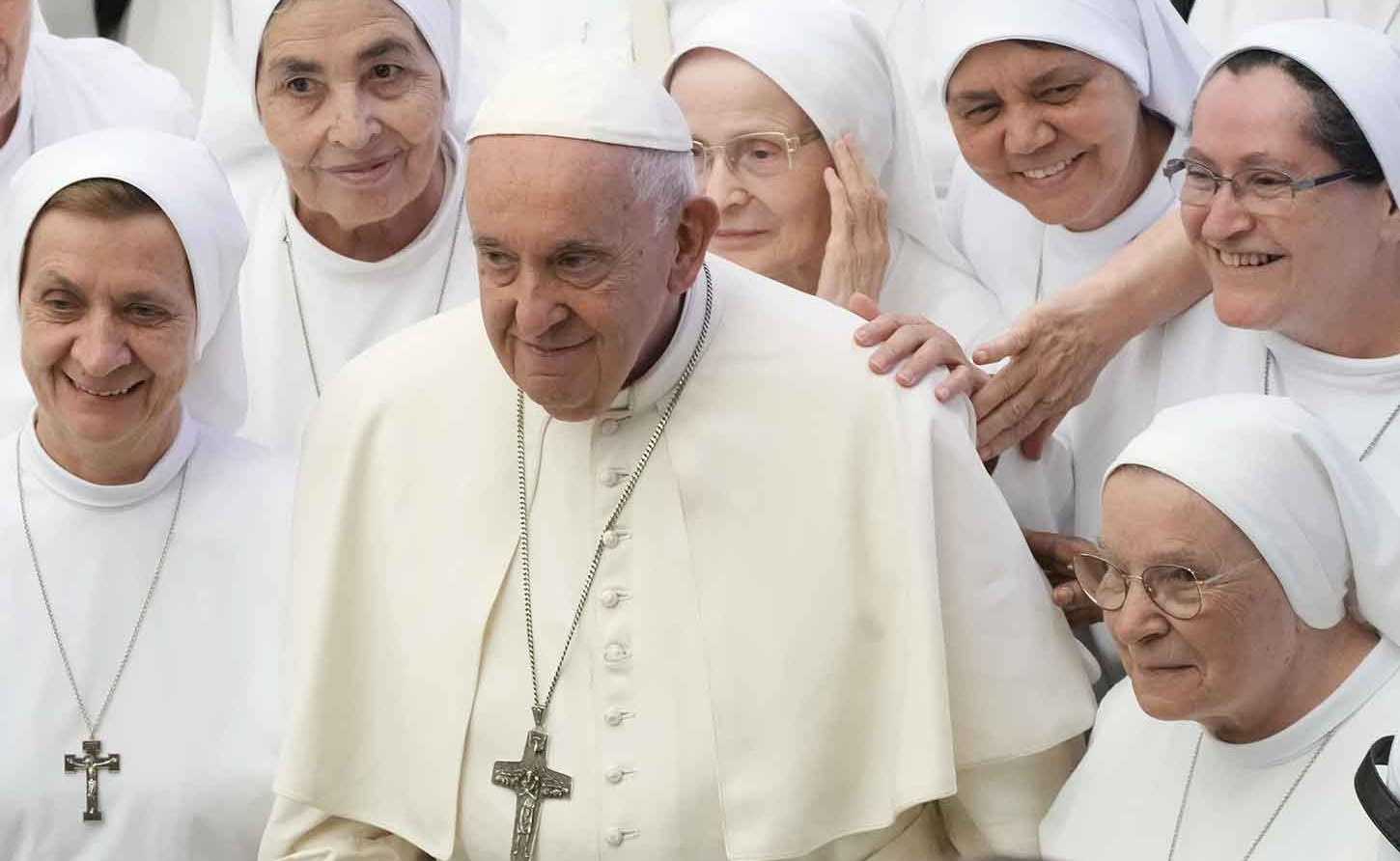 Pope Francis poses for a picture with a group of nuns during the general audience in the Paul VI hall at the Vatican, Aug. 9, 2023. (AP Photo/Gregorio Borgia)