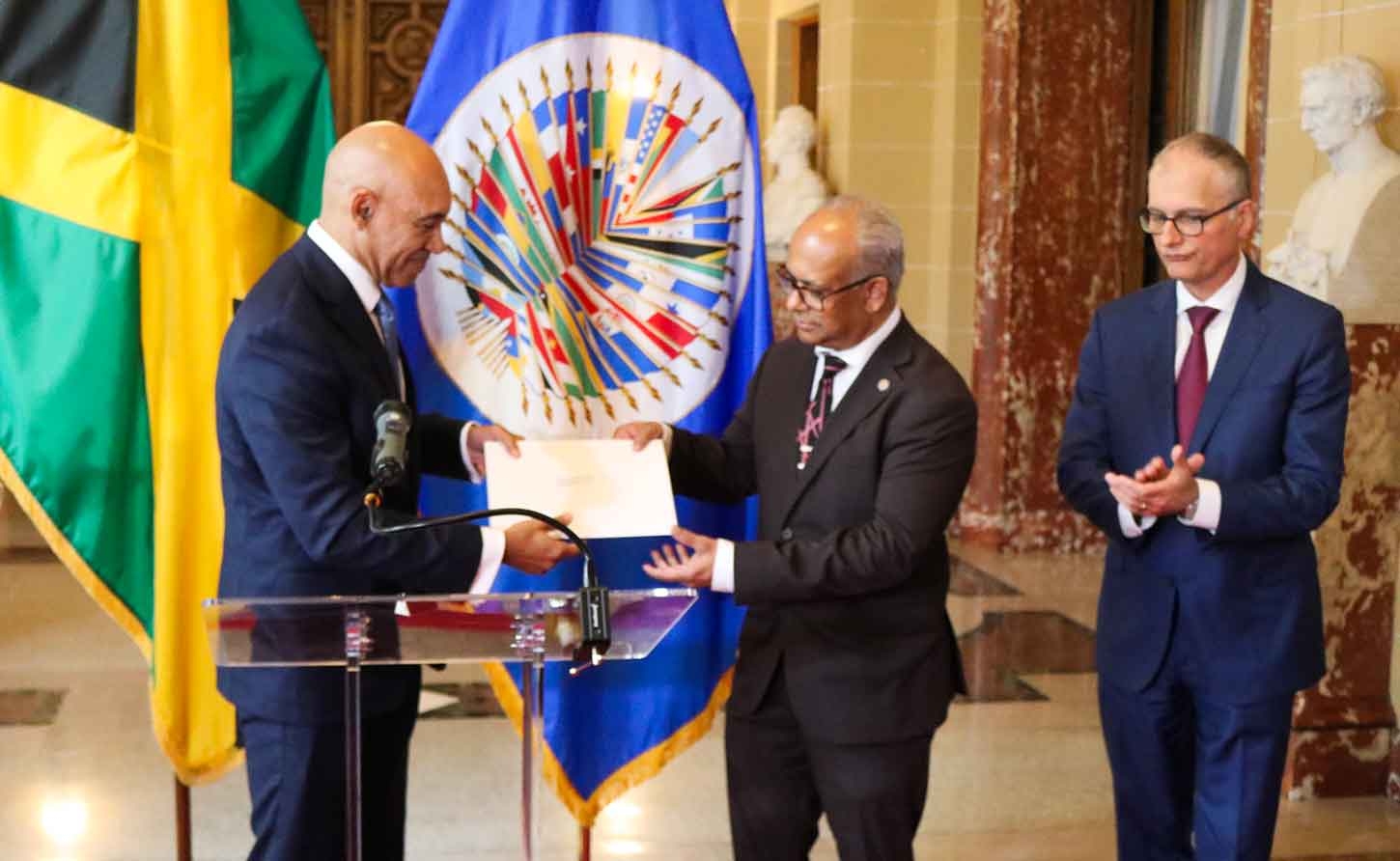 Jamaica’s Ambassador to the United States and Permanent Rep to the OAS, Major Gen. (Rtd) Anthony Anderson presents his credentials to the Secretary General of the OAS, H. E.  Albert Ramdin on June 18. At left is Assistant Secretary General , Amb Nestor Mendez. | Derrick Scott Photo.