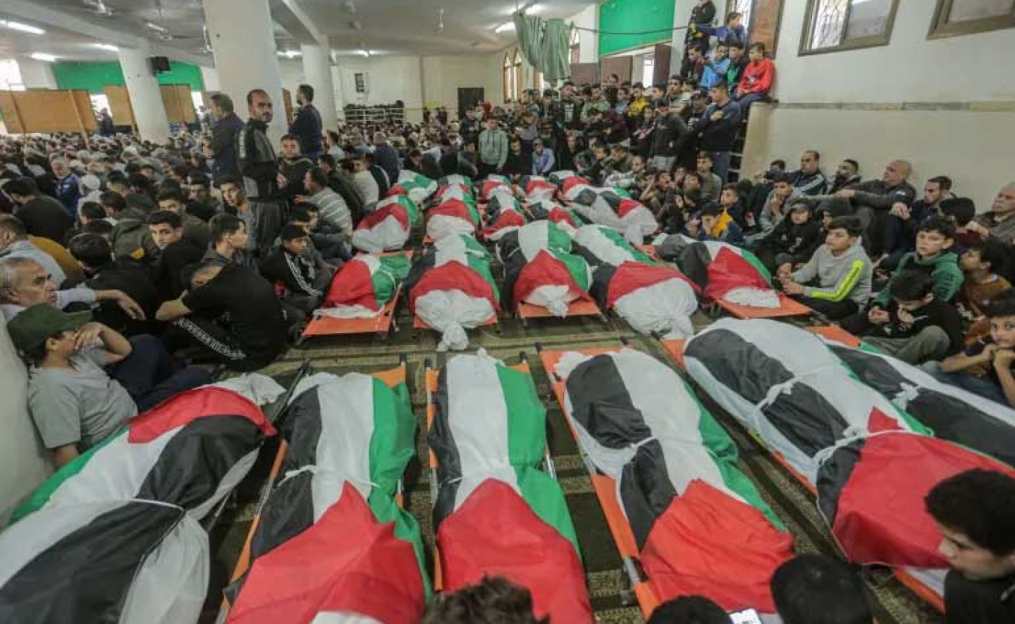 Bodies of the 21 victims of the Abu Rayya family, died in a fire that ripped through their house in Jabalia camp [Abdelhakim Abu Riash/Al Jazeera]