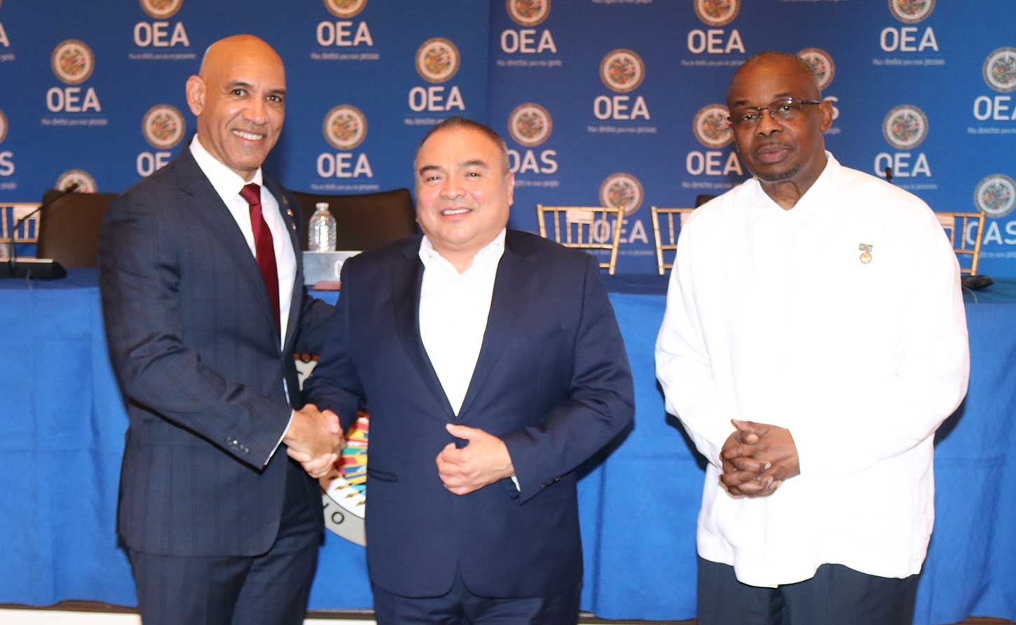 His Excellency Major General (Ret’d) Antony Anderson, bids farewell to outgoing Assistant Secretary General Ambassador Nestor Mendez. Looking on is Ambassador Steve Ferrol of Dominica, current Chair of the of the OAS Permanent Council. (Photo | Derrick Scott)
