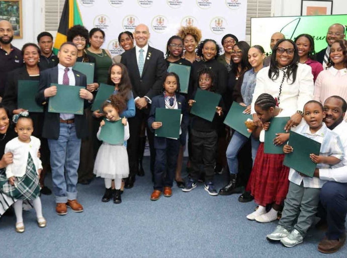 New Jamaican Citizens display their Certificatde of Citizenship at a ceremony on Friday, March 27, at the Embassy of Jamaica in Washington, D.C. , which formally recognized 27 Jamaican nationals — newly naturalized and those formalizing citizenship by descent. At centree is Ambassador His Excellency Antony Anderson, Jamaica’s Ambassador to the United States and Permanent Representative to the OAS who presided over the ceremony| Derrick Scott Photo