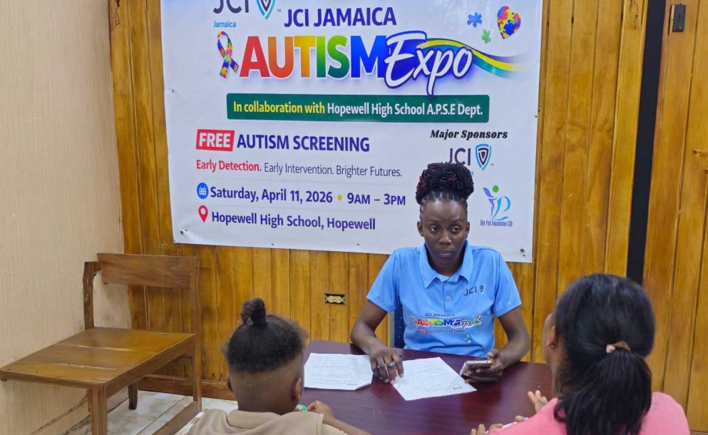 Dr. Yochel Samuels-Williams, Immediate Past President of JCI Hopewell, formerly Hopewell Jaycees with a parent and her child at the JCI Jamaica Autism Expo in Hopewell, Hanover.