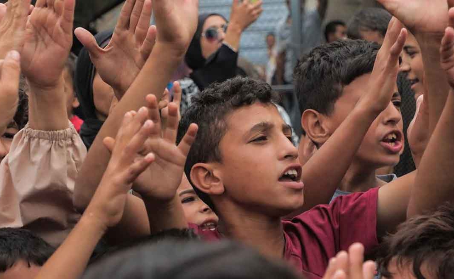 © UNICEF/Mohammed Nateel Palestinian boys celebrate the ceasefire announcement in October 2025.