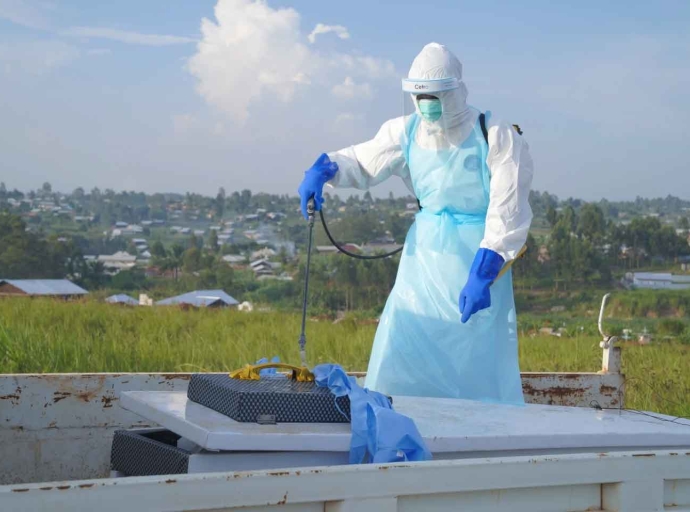 A health worker sprays the coffin containing the remains of Jacques Lobo Dhena who died of Ebola during a burial service in Bunia Ituri province, Eastern Congo August 12, 2026.| (AP Photo Dieudonne Dirole)