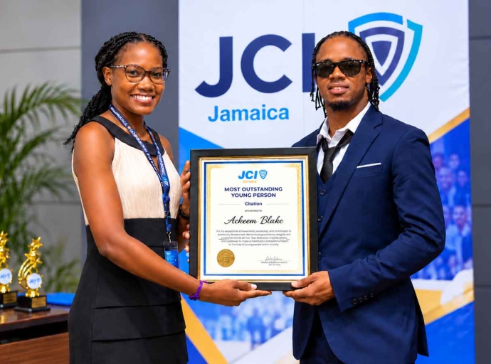 TOYP awardee Jamaica's International sprinter Ackeem Blake being presented with his citation for Honorary Membership of Junior Chamber International Hopewell by Vice President Tameka Brown at the JCI Jamaica 13th National Convention October 3, 2026 at the Grand Palladium Resort &amp; Spa, Lucea, Hanover.