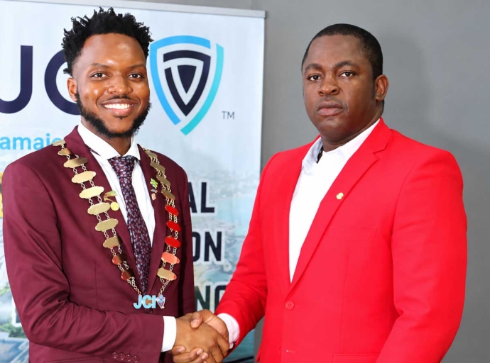 Dr. Farin Williams the newly elected National President for JCI (at right), is congratulated by outgoing President Marklon Bedward, after he was elected at JCI Jamaica’s annual convention at the Grand Palladium Resort &amp; Spa in Lucea, Hanover on Sunday, October 4.   Photo -Derrick Scott   