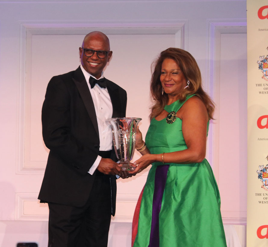 Partner at PricewaterhouseCoopers LLP , Mr. Don Christian receives The Caribbean Luminary Award presented to him by Ms Arlene Isaacs-Lowe.