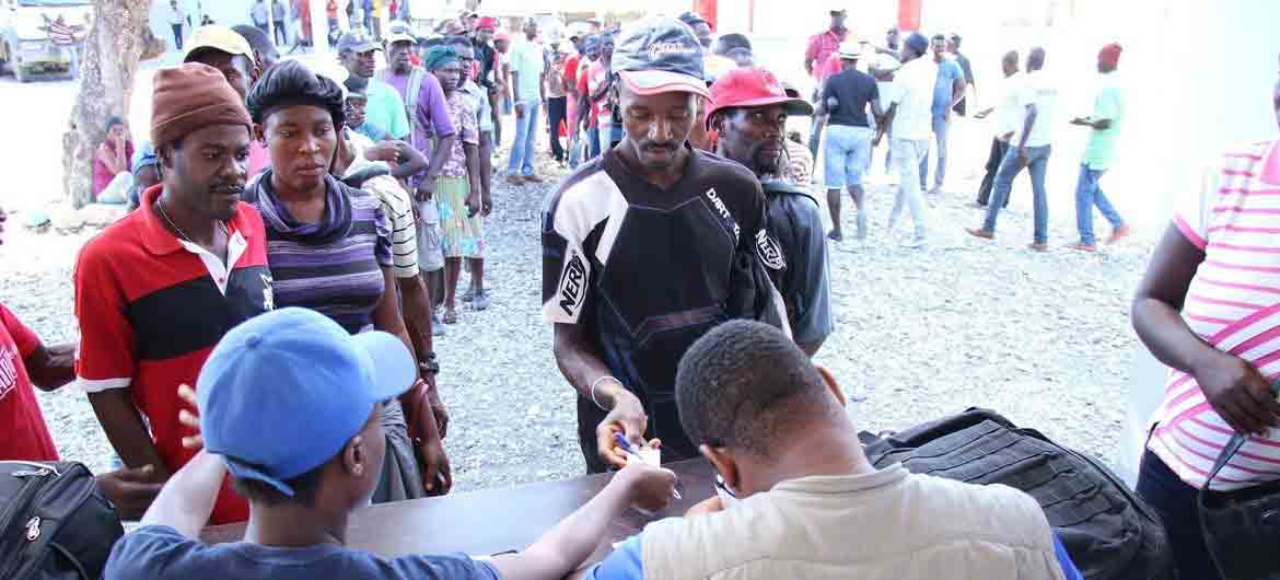 WFP/Alexis Masciarelli Haitians line up for food assistance from WFP in Chansolme, north-east department of Haiti.