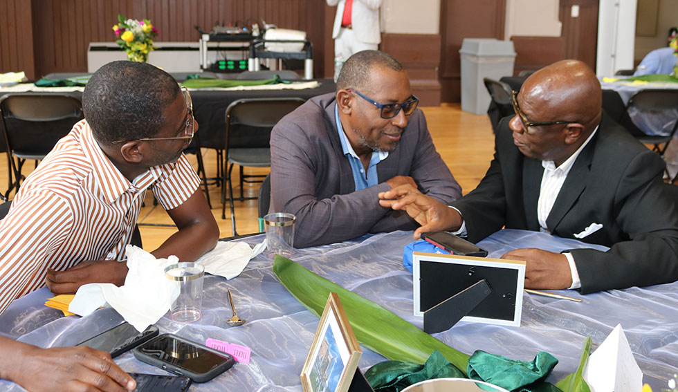 Falmouth’s Mayor Colin Gager engages the attention of Councillor for the Martha Brae Division Roydell Hamilton and Councillor for the Falmouth Division Garth Wilkinson at theFriends of Falmouth Symposium at the Major Owens Community Centre in Brooklyn New York on Saturday 25th May, 2024.|Derrick Scott Photo