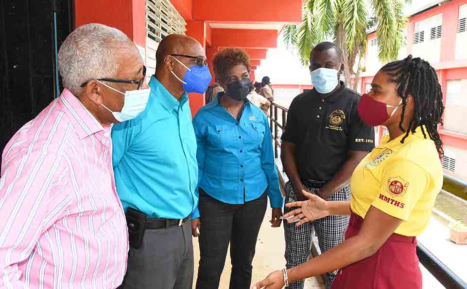 Landra Reid (R ) Grade 10 Science Scholarship recipient at the Herbert Morrison Technical High School is caught in an animated mood as she welcomed a team from Technological Solutions Limited (TSL) to her schools Career Day last Thursday, May 26.