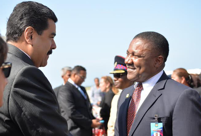President of Venezuela Nicholas Maduro (left), is greeted by  then Minister of Science, Technology, Energy and Mining, Phillip Paulwell, on his arrival at the Sangster International Airport in Montego Bay, St. James  for the 10th Anniversary Commemorative Summit of the PetroCaribe Agreement.