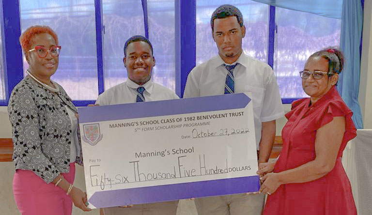 Scholarship Committee Members Carol Newman and Consuelo Ricketts award scholarships to Morgan Foster and Dayne Williams.-Photo Credit: Mr. I. Pearce.