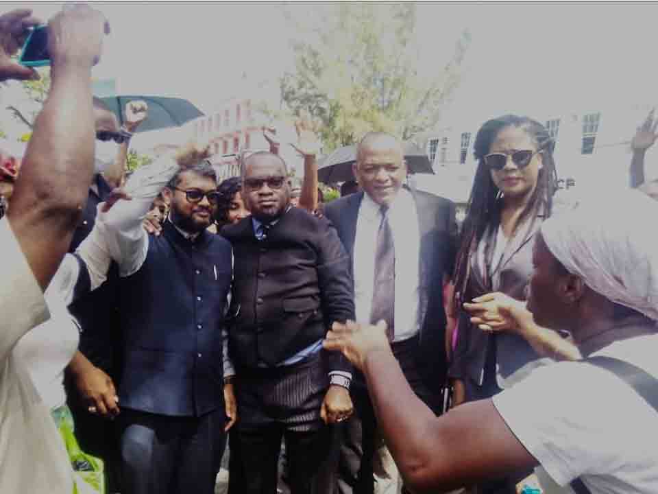 The head of Georgetown City Council, Mayor, Pt. Ubraj Narine accompanied by his attorneys Roysdale Forde and Amanza Desir, as well as his co-accused, Member of Parliament Sherod Duncan, shortly after emerging from the Court after he was arrested on the instruction of the central government, having stood firm in support of the vendors right to occupy Council property with its permission.