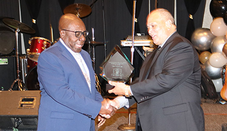 Jamaican Actor and Comedian Oliver Samuels accepts his award for Arts and Culture from President of the Jamaican Organization of New Jersey (JON-J) Owen Eccles, at the organization’s 25th anniversary gala and Jamaica’s 61st anniversary celebrations at the Newark Airport Marriott Hotel in New Jersey on Saturday August 26, 2023 | Derrick Scott Photo.