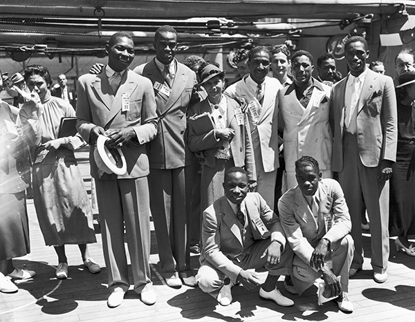 15 Jun 1936 — Original caption: 6/15/1936-New York, New York- These are the Olympic athletes who will do their stint for Uncle Sam in the big games in Berlin. Left to right rear: Dave Albritton, ans Cornelius Johnson, record high jumpers; Tidye Pickett, woman track star; Ralph Metcalfe, sprinter; Jim Clark boxer and Matthew Robinson, sprinter. In front are John Terry (left) weight lifter and John Brooks, Broadjumper. — Image by © Bettmann/CORBIS