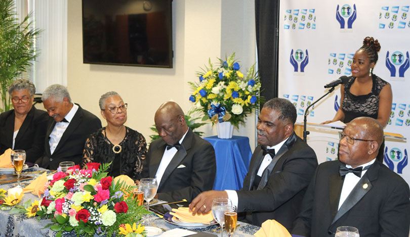 Minister/Counsellor for Trade at the Jamaican Embassy in Washington Ms Aliecia Taylor delivers remarks on behalf of Ambassador Audrey Marks at the launch of the Northern Caribbean University’s International Development Foundation (NCUIDF) on Sunday April 28, at the Atrium Sligo Seventh Day Adventist Church at Takoma Park Maryland. Seated from left are: Mrs. Ruth Rutherford; Dr. Patrick Rutherford, Executive Director of the Foundation; Mrs. Yvonne Melbourne; Foundation Board Chairman Dr. Bertram Melbourne; Treasurer, Seventh-Day Adventist World, Pastor Paul Douglas; President of NCU, Dr. Lincoln Edwards, and retired Judge of the Court of Canadian Citizenship, Dr Pamela Appelt.