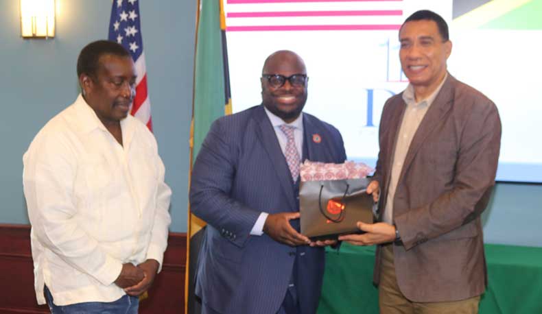 Prime Minister Andrew Holness accepts a gift from The President of Delaware State University Dr. Tony Allen on Thursday at a luncheon given in his honour by the University. At left is Member of Parliament for St Mary Western, Robert Montague | Derrick Scott Photo..