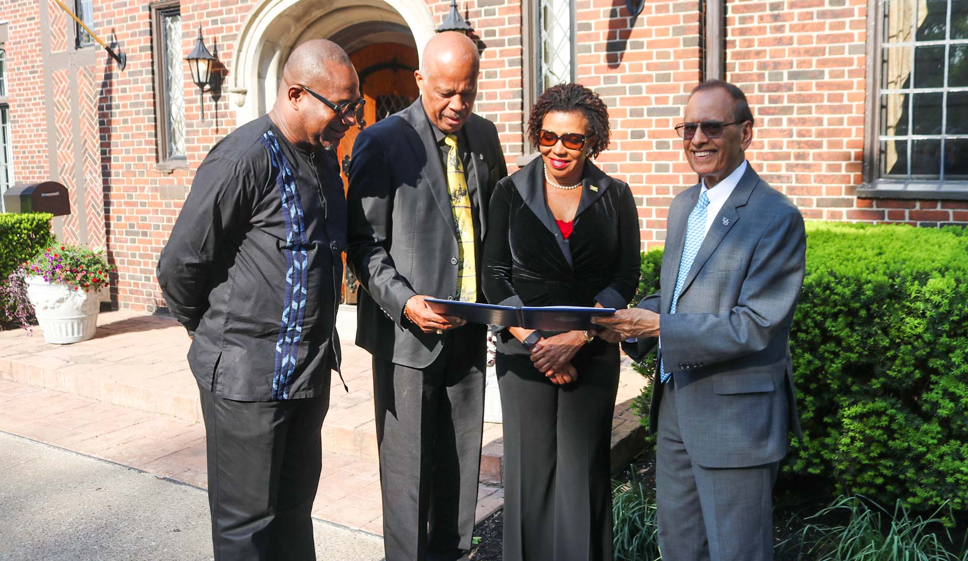 Jamaica’s ambassador to the United States Audrey Marks(centre) along with UWI Mona principal Professort Densil williams, Vice Chancellor Hillary Beckles and University at Buffalo President Satish K. Tripathi peruse the memorandum of understanding signed between both universities to help achieve the United Nations 2030 Sustainable Development Goals.