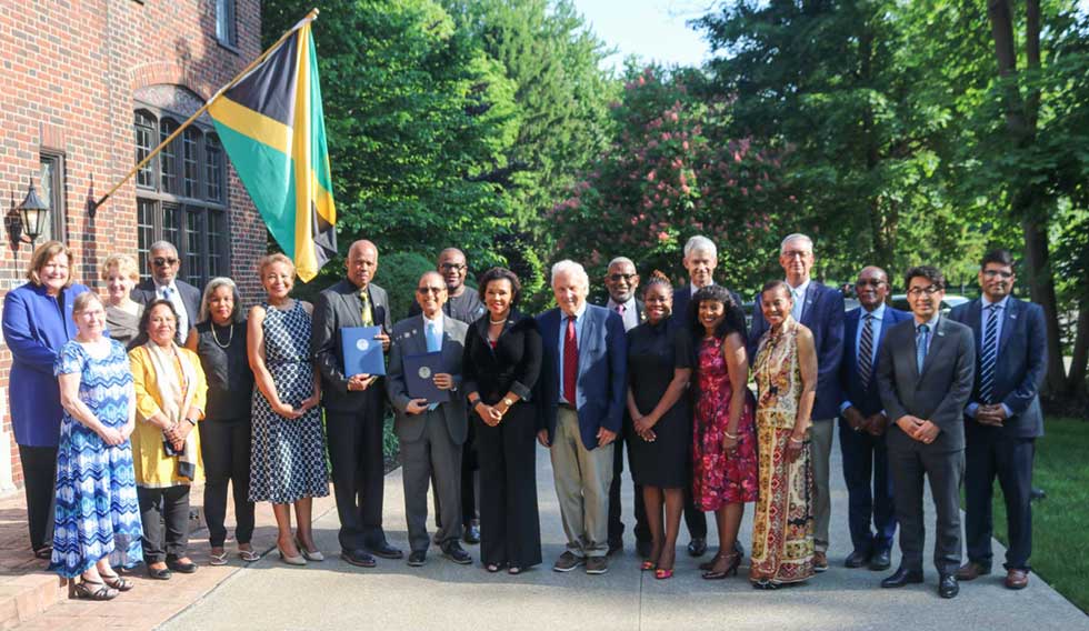 Jamaica's Ambassador to the United States (centre) along with UWI Vice Chancellor Sir Hillary Beckles and President of the University of Buffalo, pose for a photogrph with members of the academic teams from SUNY University at Buffalo and leaders of the University of the West Indies (UWI), aslong with members of the Jamaican community in Buffalo following the signing of a memorandum of understanding between the two universities on May 20, to help achieve the United Nations 2030 Sustainable Development Goals.