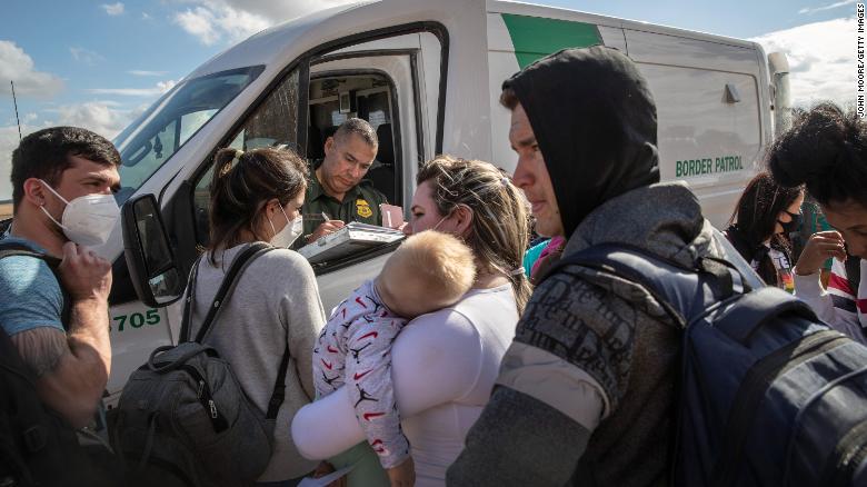 Cuban migrants wait to be transported to a US Border Patrol processing center in Yuma, Arizona on December 9, 2021.