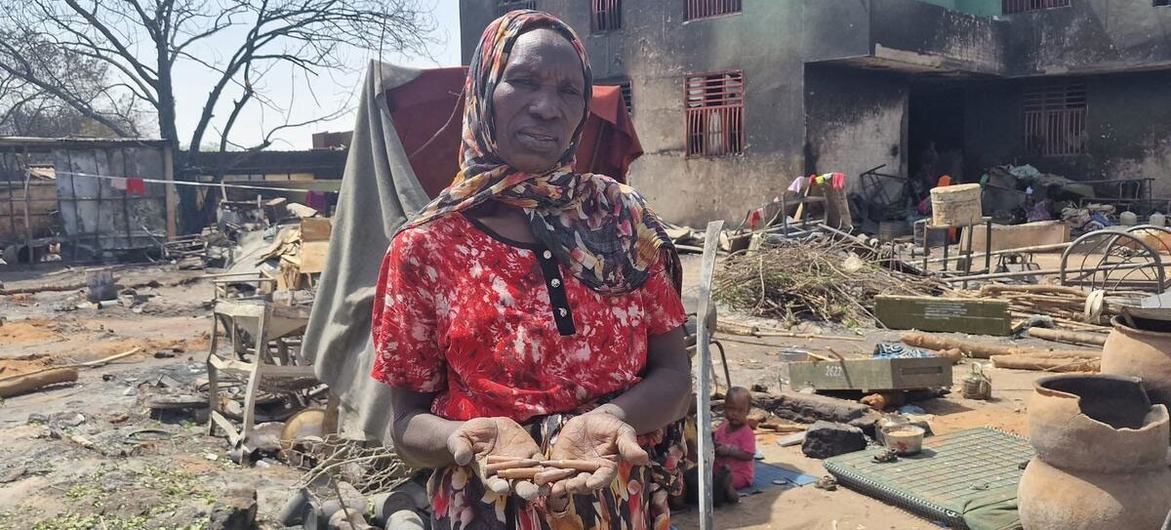 © UNOCHA/Mohamed Khalil A woman holds gun shells discharged in fighting in West Darfur.