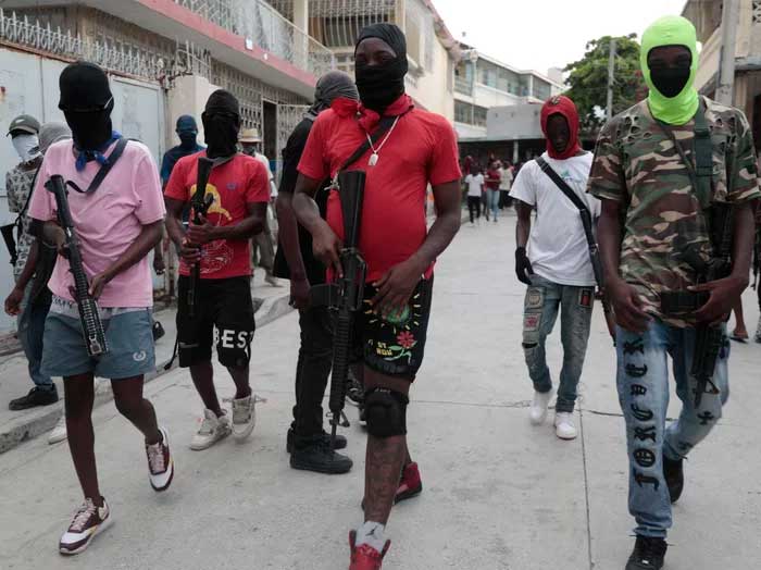 Armed members of "G9 and Family" march in a protest against Haitian Prime Minister Ariel Henry in Port-au-Prince, Haiti, Tuesday, Sept. 19, 2023. Odelyn Joseph/AP