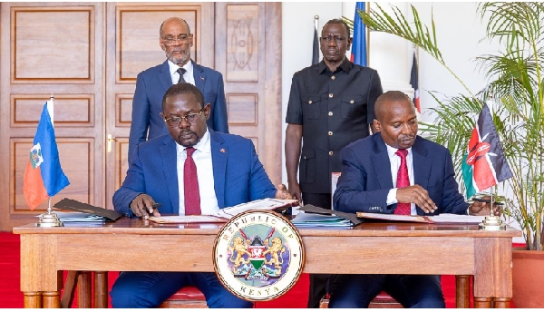 Haiti Prime Minister Ariel Henry (L) and President William Ruto witness the signing ceremony in which Kenya will send 1000 police personnel to lead the multinational force in Haiti.