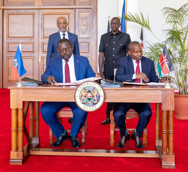 President William Ruto and Haiti Prime Minister Ariel Henry witnessing the signing ceremony of agreement on deployment of police to the Caribbean nation at State House on March 1, 2024 Image: PCS