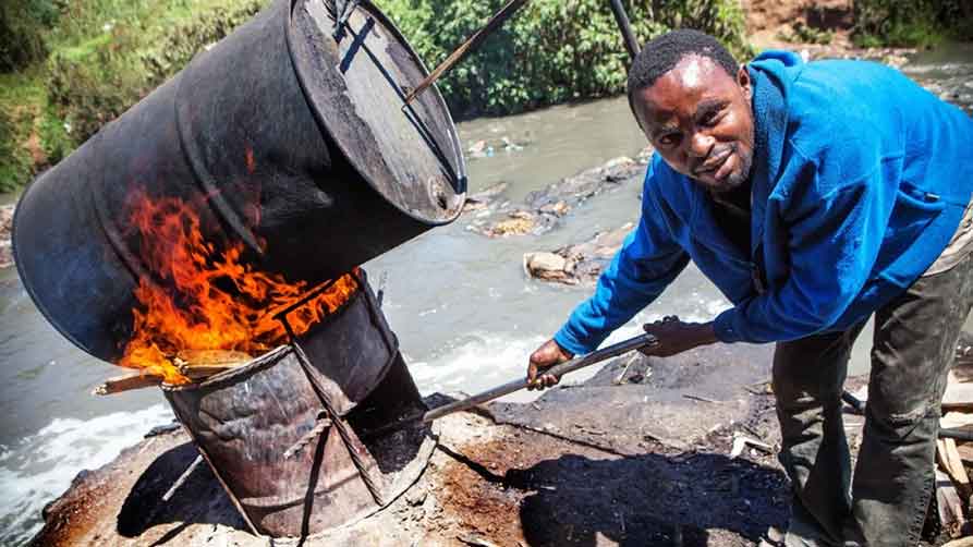 "Changaa", the Kenyan version of moonshine whisky, is often brewed in rivers contaminated with sewage. In Mathare slum, rich Kenyans and Indian businessmen invest in its production, but never come into the slum. They just collect the money through "runners".