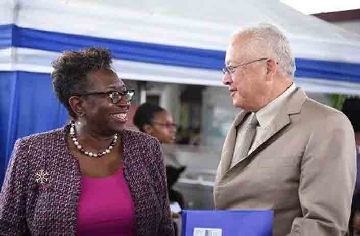 Justice Minister, Delroy Chuck (right) speaks with Director of Public Prosecutions (DPP), Paula Llewellyn, at the opening ceremony of the Ministry's Integrated Justice Fair on October 24,2023 at the Half-Way-Tree Transport Centre, St Andrew.