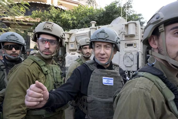 Prime Minister Benjamin Netanyahu, centre, receives a security briefing with commanders and soldiers in the northern Gaza Strip in December. Avi Ohayon/GPO/AP
