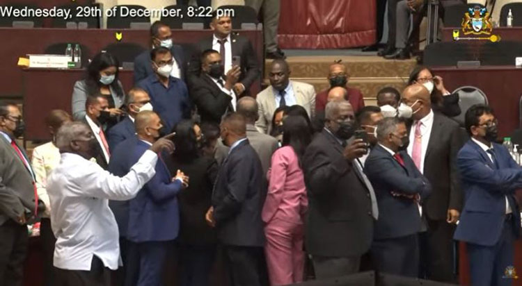 Members of Parliament from the Government surround Senior Minister within the Office of the President with responsibility for Finance Dr. Ashni Singh as he presented the Natural Resource Fund (NRF) Bill (Photo: Screenshot from YouTube livestream)