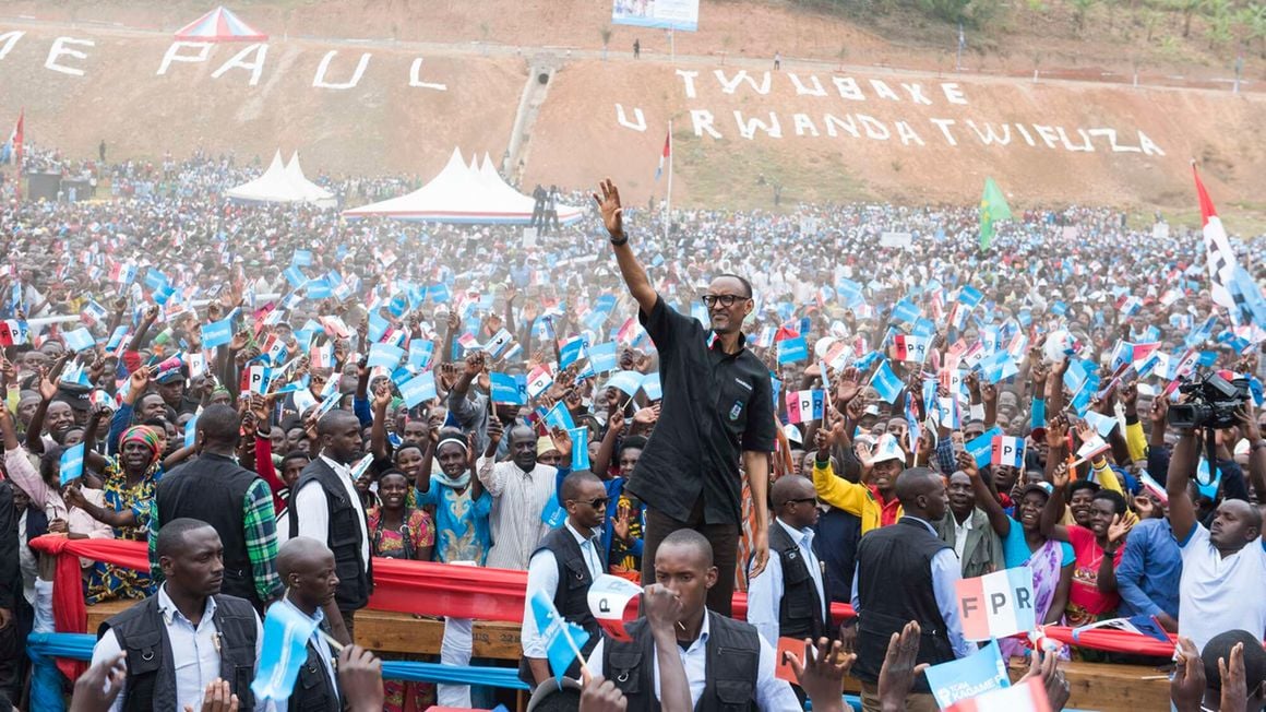 Rwanda’s President Paul Kagame greets a crowd of supporters as he arrives for a campaign rally on July 31, 2017.