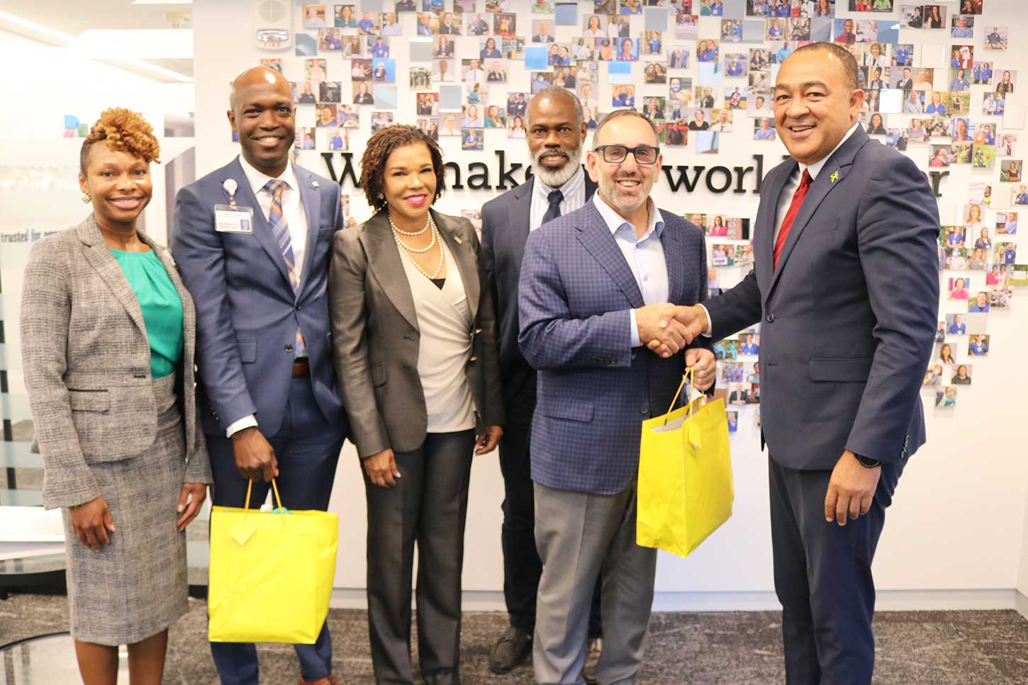 President of Hartford HealthCare Dr. Jeffery Flaks accepts a gift from Health and Wellness Minister Dr. Christopher Tufton . Looking on from left are Regional President of Hartford HealthCare Gina Calder, Vice President Hartford HealthCare Keith Grant, Jamaica's Ambassador Audrey Marks and UWI Professor Dr Marvin Reid.