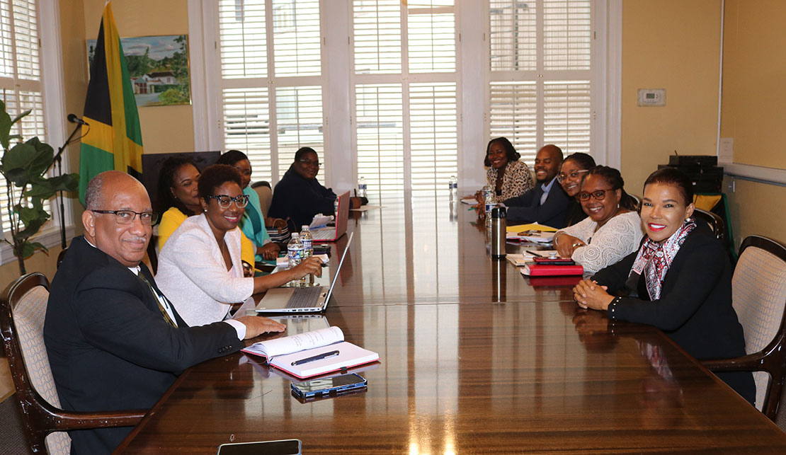 Jamaica’s Ambassador to the United States Audrey Marks (right) and members of the Embassy staff (right) and the Chief Executive Officer of the Passport, Immigration and Citizenship Agency (PICA) Mr. Andrew Wynter (left) and his officers during a meeting on Tuesday October 25 at the Embassy of Jamaica in Washington.| Derrick Scott Photo