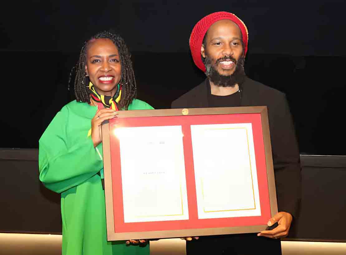 Jamaican-American Congresswoman Yvette Clarke presents A copy of the resolution to Ziggy Marley, son of Bob Marley, recognize the life and legacy of legendary reggae artist Robert ‘‘Bob’’ Nesta Marley .the presentation was made at a special screening of the BOB MARLEY: ONE LOVE film at the Motion Pictures Association in Washington, on Tuesday February 13. (Photon Derrick Scott)